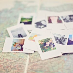 A collection of Polaroid memories spread across a map, symbolizing travel adventures.